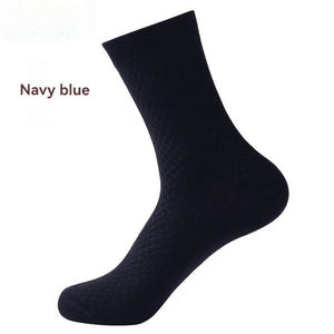 Elorvian bamboo sock in navy blue, mid-calf crew, on foot form