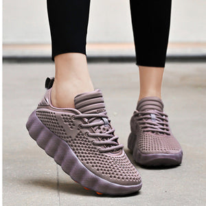 Purple sneakers worn with black leggings on a light background