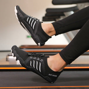 Three-panel collage showing a person wearing black athletic running shoes with white stripe-like side details while standing on a treadmill in a gym. The top panel shows the shoes in motion with black leggings, the bottom-left shows them with gray leggings, and the bottom-right shows them from the side.