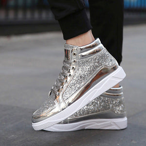 Silver glitter high-top sneakers with white soles worn by a person on a blurred background
