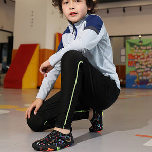 Child wearing colorful shoes in an indoor setting