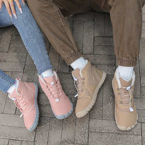 Two sets of feet wearing pink and brown shoes on a textured surface, with a close-up of pink shoes on a snowy background.
