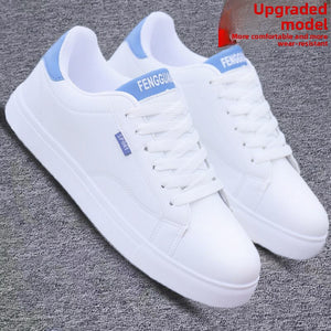 White ActiveCore sneakers with blue heel accents shown from the front side angle
