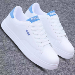 White ActiveCore sport sneakers with blue heel accents on gray fabric