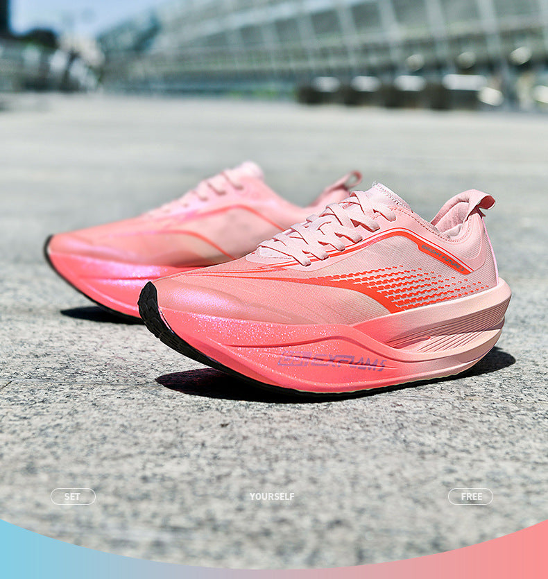 Pink running shoes on a road with blurred background