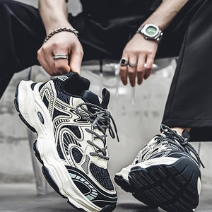 Person wearing black and white sneakers with a focus on the shoes.