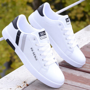 White ActiveCore sneakers with black and gray heel accents displayed outdoors
