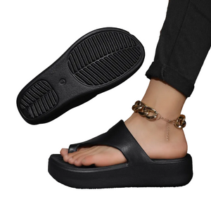 Black sandals worn with a neutral background