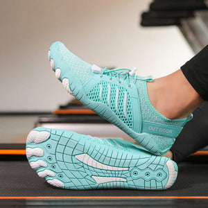 A pair of light aqua athletic sneakers shown in two contexts: one close-up of the shoes on a treadmill, and one lifestyle shot of a person riding a stationary bike in a gym. The shoes feature a breathable mesh upper, a thick cushioned sole with a wavy pattern, and white accents.