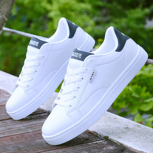 White ActiveCore sport sneakers with black heel accents displayed outdoors