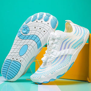 A pair of women's outdoor water shoes shown on a colorful background, with one shoe displaying the white, light blue, and gray textured sole and the other showing the side profile. The image includes product specifications text at the bottom.