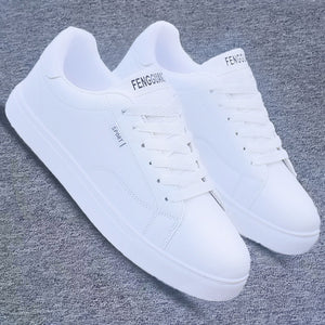 All-white ActiveCore sport sneakers shown as a pair on gray fabric