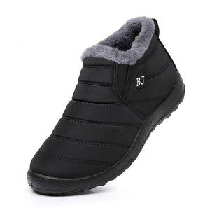 Black winter boot with gray fur lining on a white background