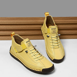 Yellow and white sneakers on a wooden and beige surface
