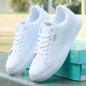 All-white ActiveCore lace-up sneakers displayed beside blue shoe boxes