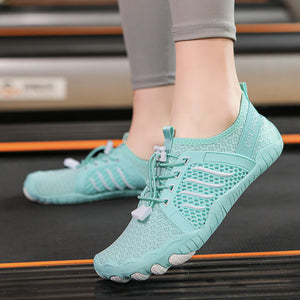 Teal athletic shoes worn on a treadmill