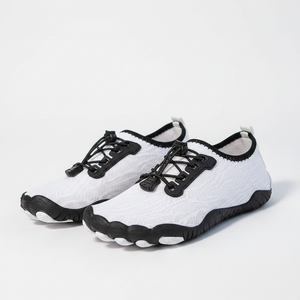 White and black athletic water shoes with a lace-up front, shown on a treadmill with a person's legs visible.