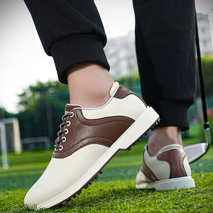 Brown and white golf shoes on a person standing on grass with a blurred background