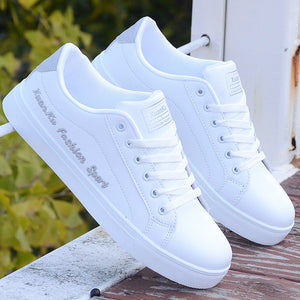 All-white ActiveCore sneakers with printed side detail displayed outdoors