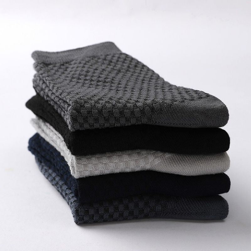 Stack of folded Elorvian bamboo socks showing diamond-textured knit in five colours