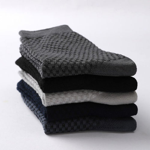 Stack of folded Elorvian bamboo socks showing diamond-textured knit in five colours