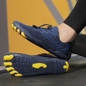 A pair of minimalist toe-touch athletic shoes in navy blue and bright yellow, with one shoe shown from the side and the other from the sole, worn with black leggings.