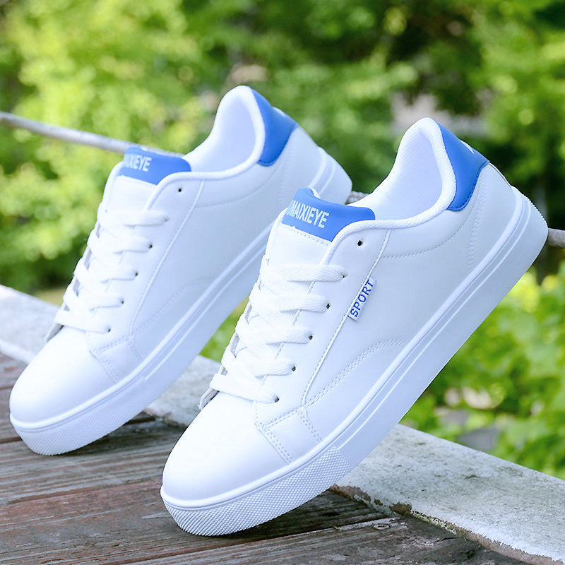 White ActiveCore sport sneakers with blue heel accents displayed outdoors