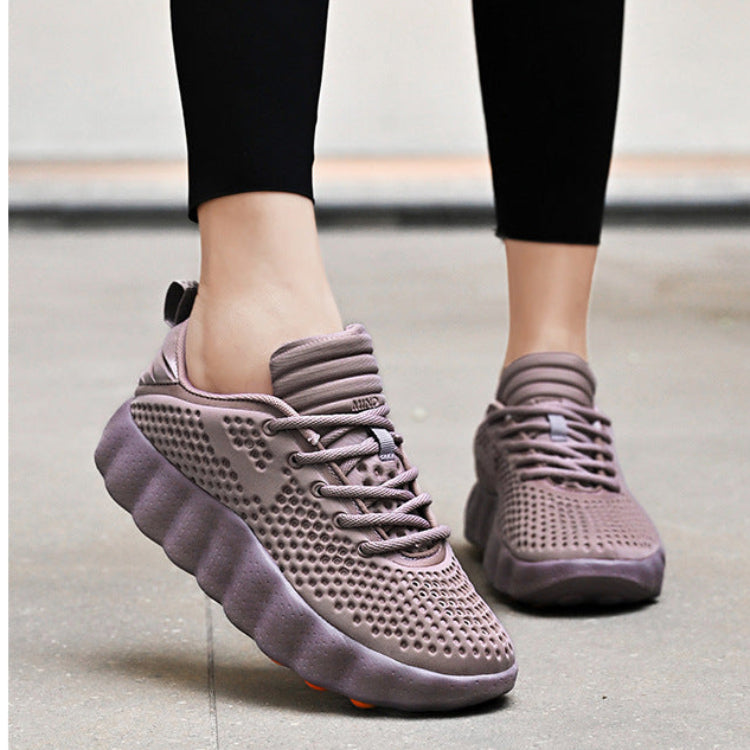 Purple sneakers worn with black leggings on a light background