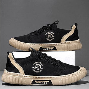 Black and beige sneakers with brand logo on a gray background