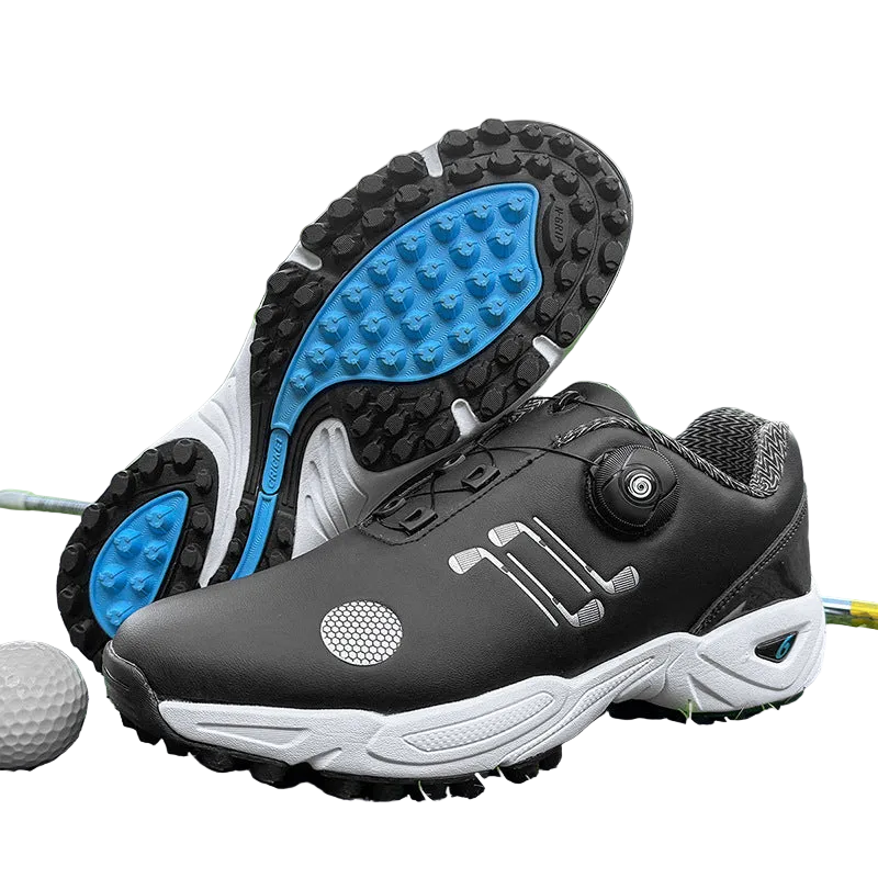 A pair of black and white golf shoes with bright blue outsole accents, displayed on a green grass field with a golf ball nearby. One shoe is shown from the side and the other from the sole, highlighting the tread and dial closure system.