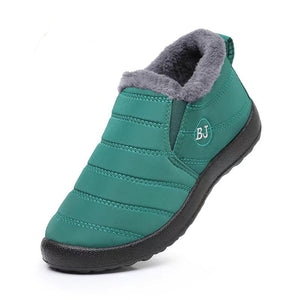Green slip-on shoe with gray lining and flame icon on a white background