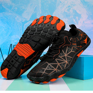 Black and orange athletic shoes with geometric sole design on a colorful background