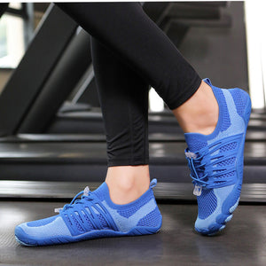 A person wearing bright blue athletic water shoes with black leggings, standing on a treadmill.