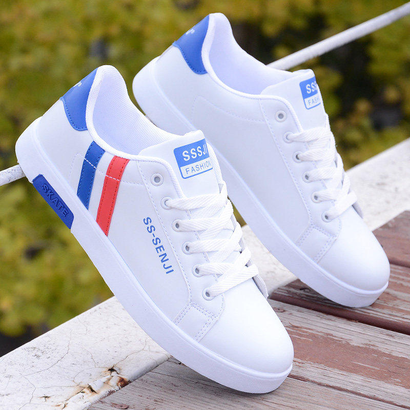 White ActiveCore sneakers with blue and red heel accents displayed outdoors