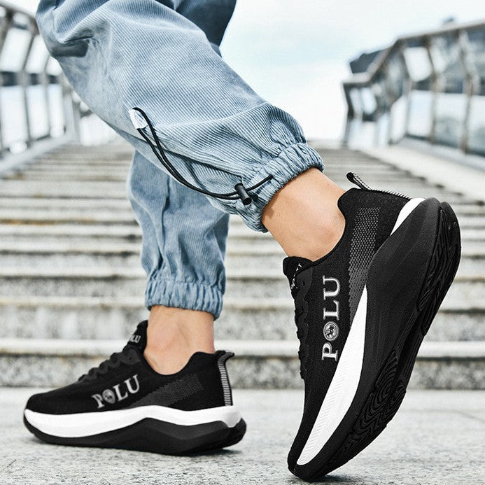 A person wearing black and white running shoes with light blue jogger pants, shown from the knees down on outdoor concrete stairs. The image includes marketing text at the top reading 'RUNNING SHOES' and 'Light and comfortable gait'.