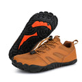 Brown hiking shoes with black and orange soles on a white background