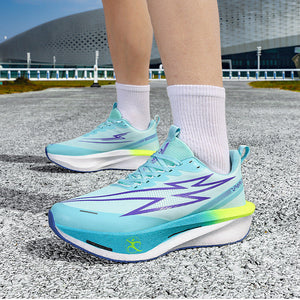 Person wearing light blue running shoes with a star design on a road with a building in the background